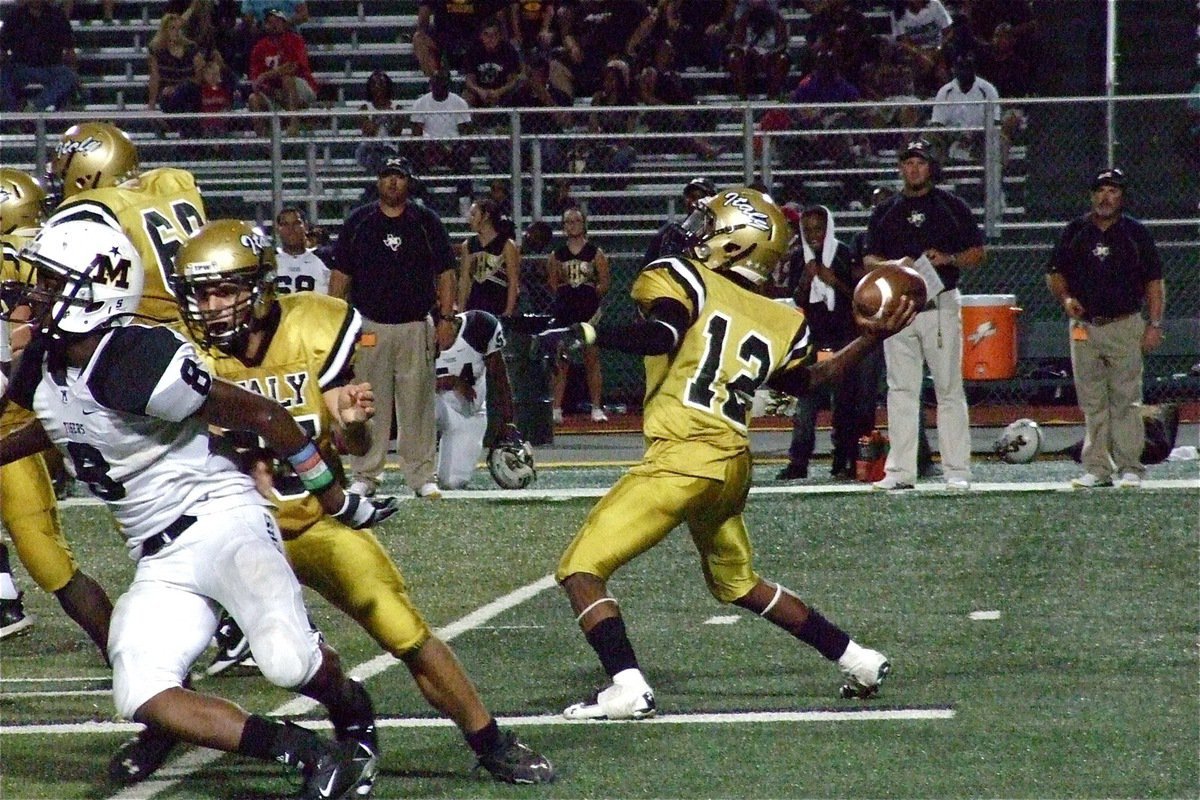 Image: Cody Medrano(75) and Kevin Roldan(60) help give Eric Carson(12) time to pass in the pocket.