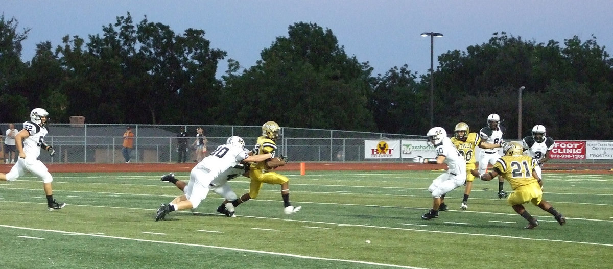 Image: Quarterback Eric Carson(12) gains yards for Italy.