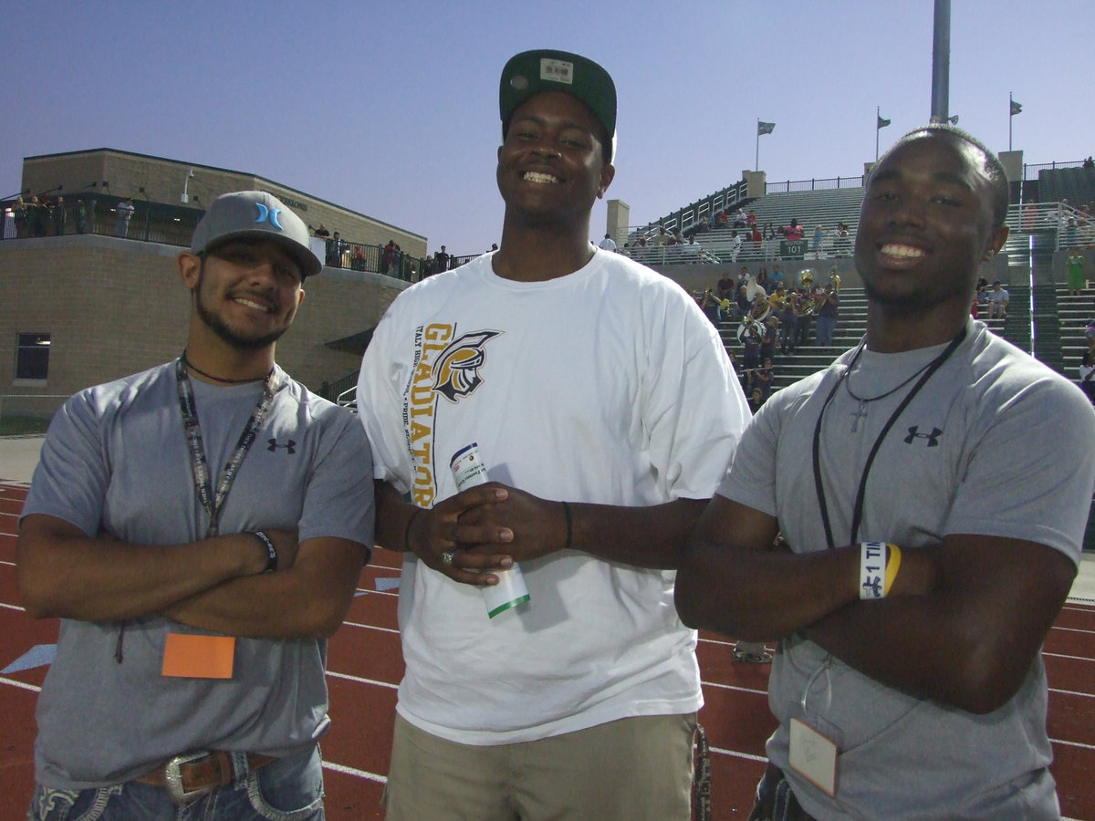 Image: Alumni status: Michael “Taz” Martinez, Larry Mayberry, Jr. and Jasenio “The Beast” Anderson are part of the Gladiator tunnel crew.