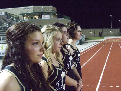 Image: The Lady Gladiator Cheerleaders take a moment to watch the game.