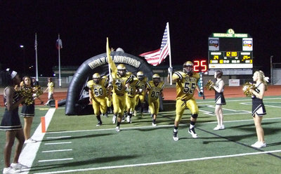 Image: Zackery Boykin(55) and Cole Hopkins(9) raise the flags and lead the Gladiators out for the second half.