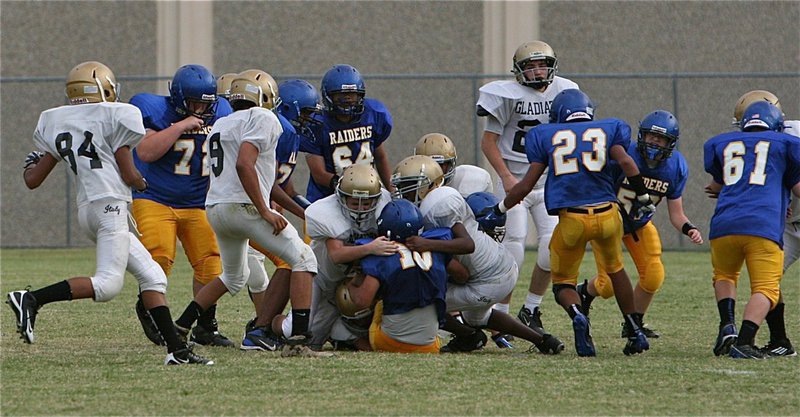 Image: The Italy Junior High defense brings down a Sunnyvale Raider running back.