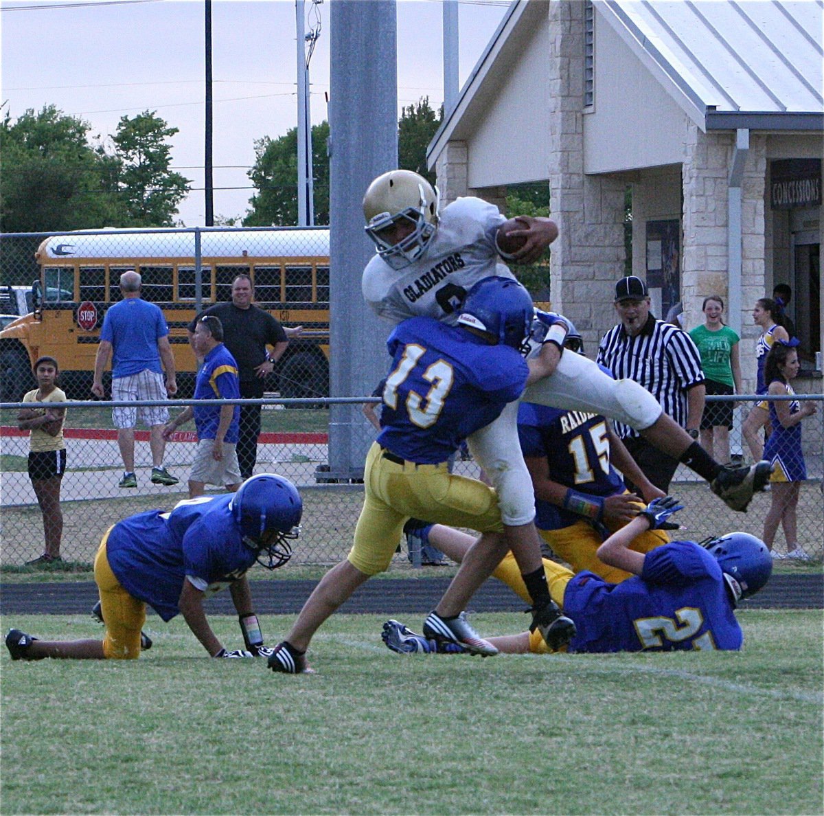 Image: Quarterback Devonteh Williams(9) is finally wrangled by the Raider defense.