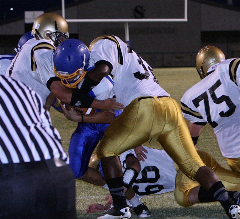 Image: Colin Newman(71), Billy Moore(32) and Kyle Fortenberry(66) keep a Sunnyvale back from reaching the end zone.