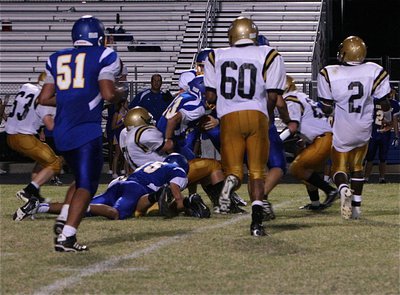 Image: Colin Newman(71) pulls down a Raider runner at the line-of-scrimmage.