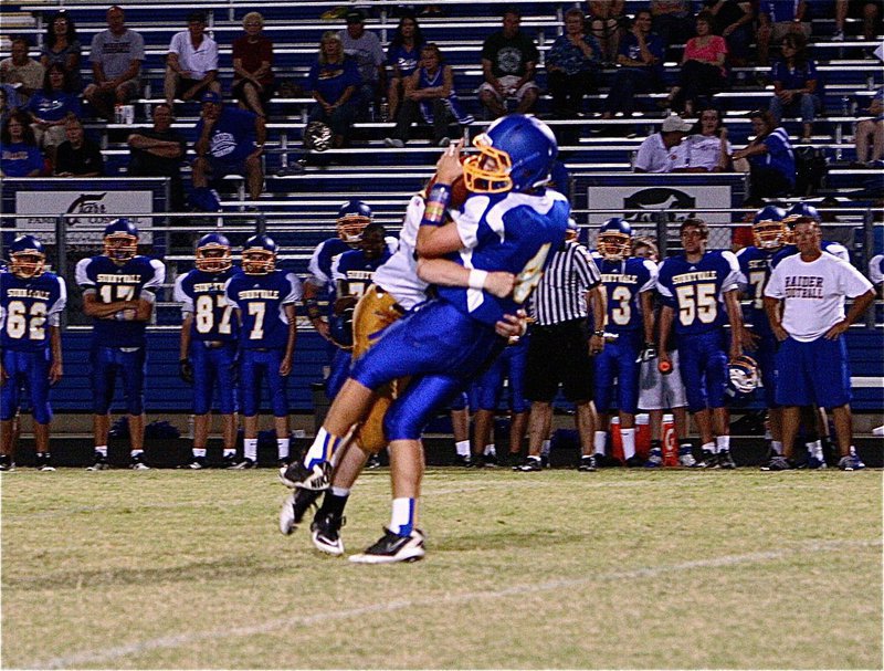 Image: Whammo! John Escamilla(63) drills the Sunnyvale quarterback who never saw the Italy linebacker blitzing.