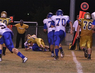 Image: Outside linebacker Cody Medrano(75) makes the tackle on the edge.