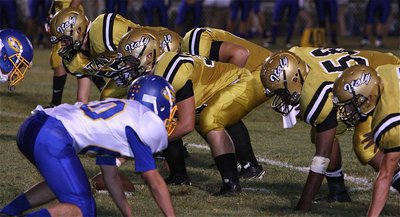 Image: Center Zain Byers(50) gets help blocking up front from teammates Zackery Boykin(55), Kevin Roldan(60), Darol Mayberry(58) and Cody Medrano(75).