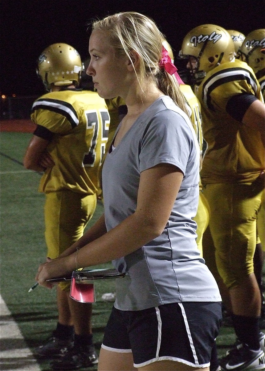 Image: Lady Gladiator Jaclynn Lewis helps with the football team stats.