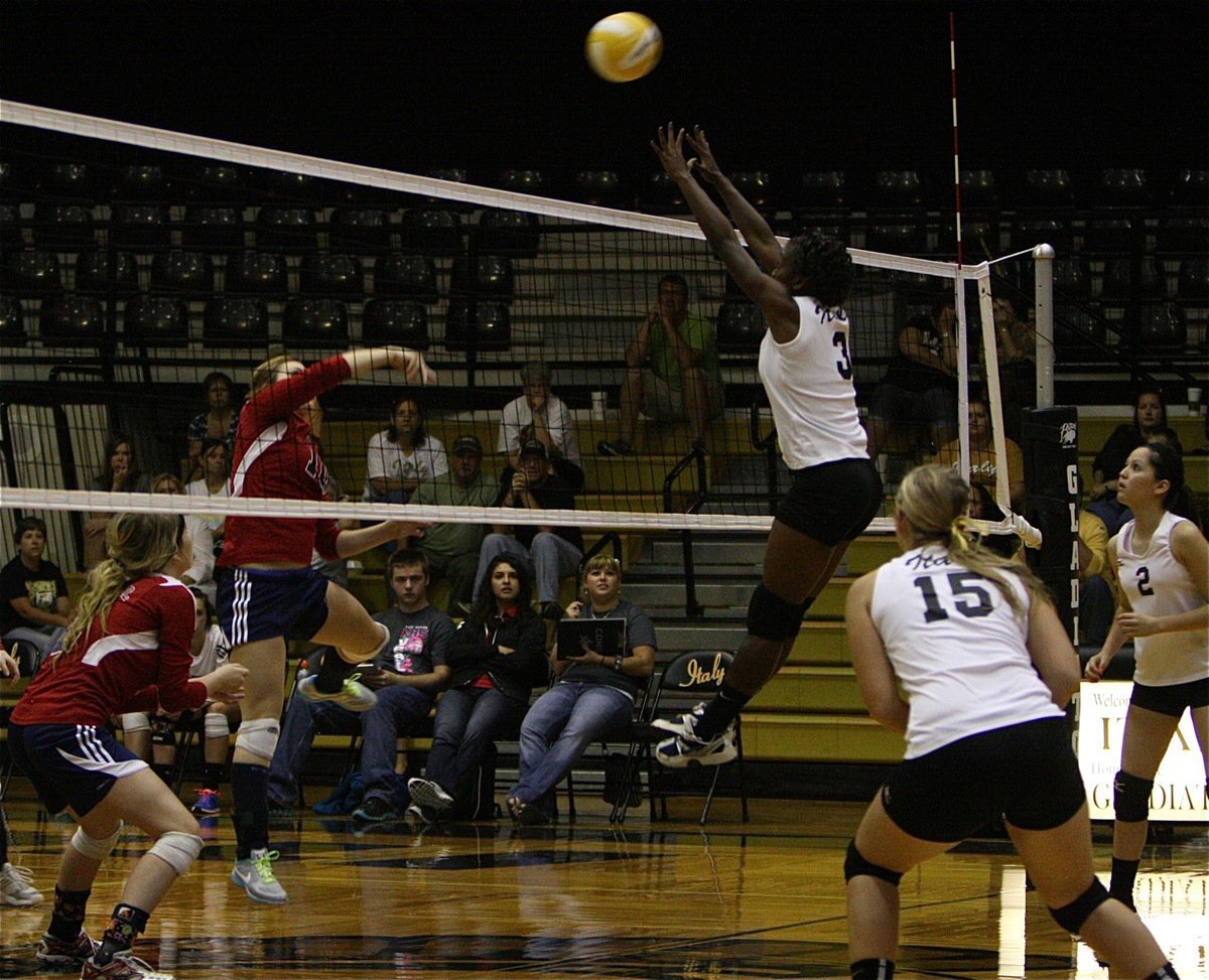 Image: Lady Gladiator Kortnei Johnson(3) rises at the net.