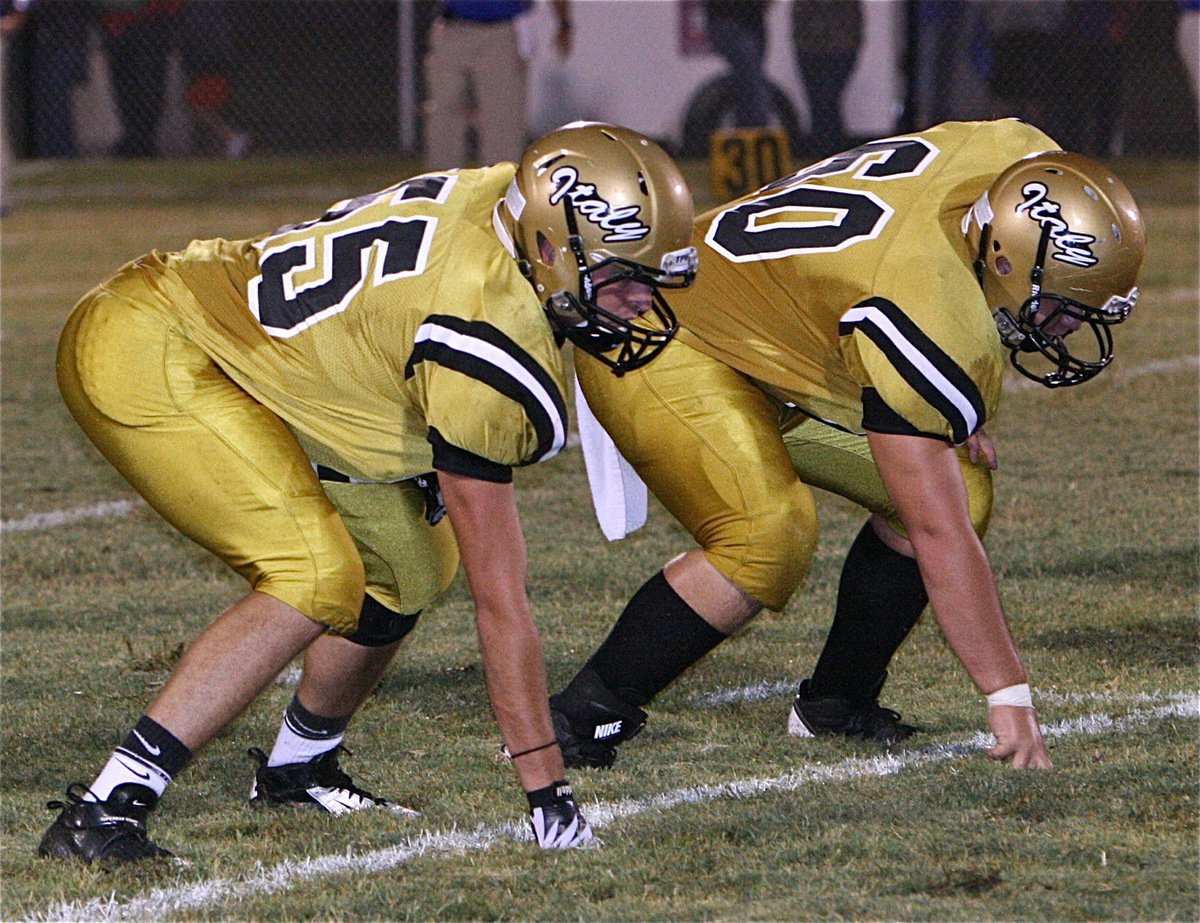 Image: Senior tackle Zackery Boykin(55) and junior guard Kevin Roldan(60) before the snap.