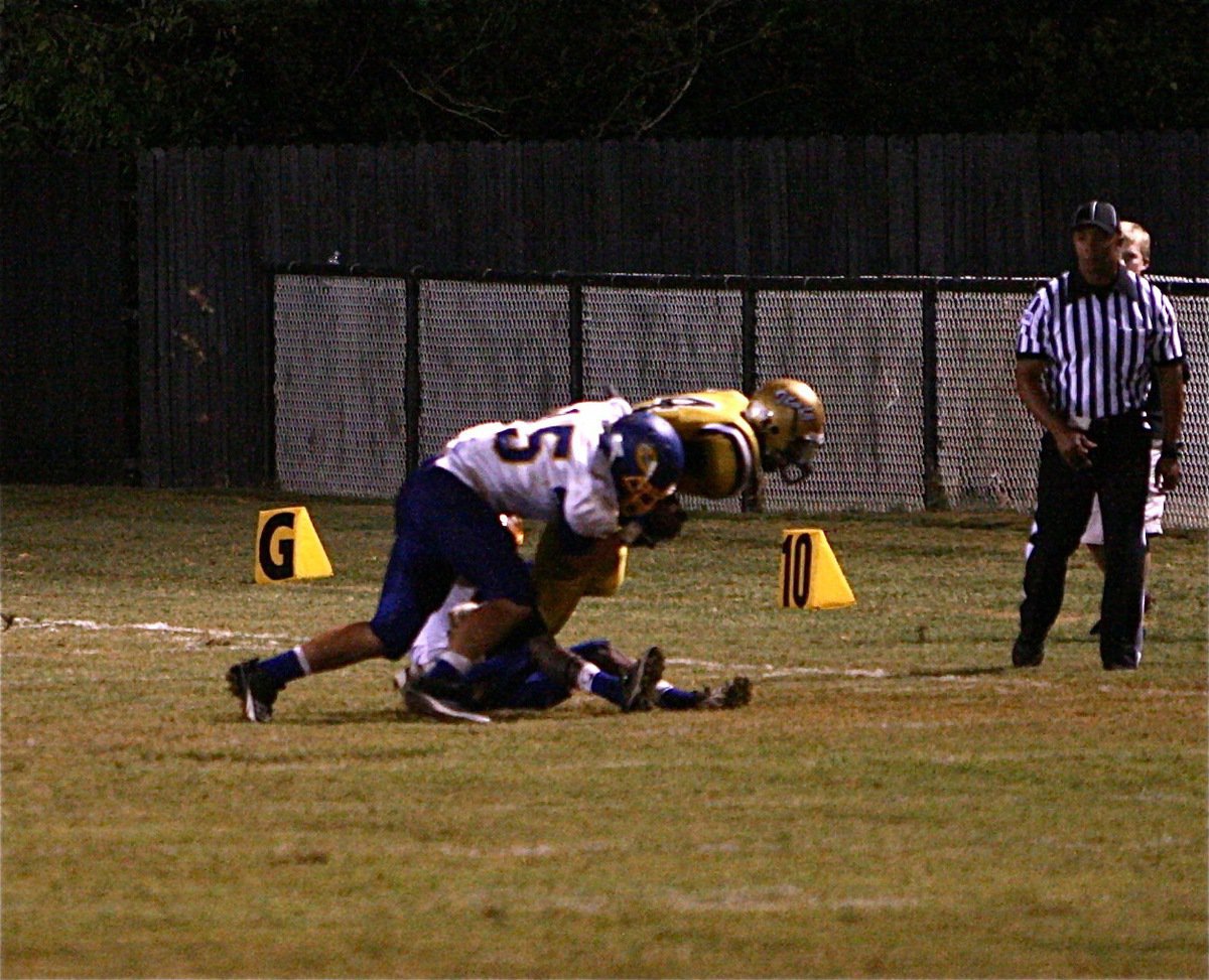 Image: Junior receiver Trevon Robertson(4) hauls in a pass from Eric Carson and surges upfield for extra yardage.