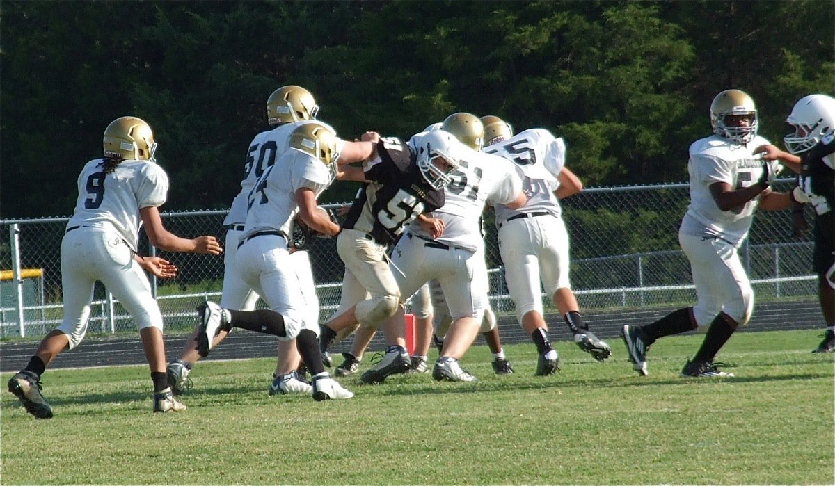 Image: Devonteh Williams hands off to Joe Celis(24) who follows Aaron Pittmon(50), Austin Pittmon(51), David De La Hoya(55) and Kenneth Norwood, Jr.(54) closer to the end zone against Hubbard.