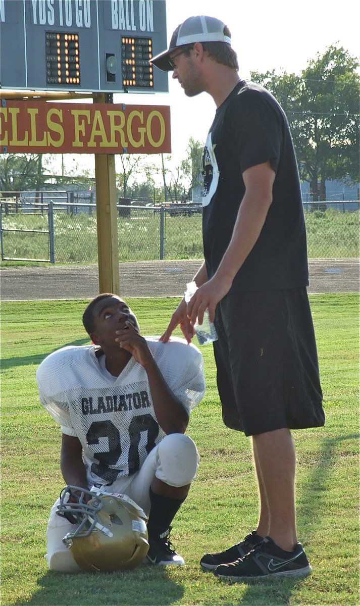 Image: Kendrick Norwood(20) looks to Coach Nate Skelton for guidance during halftime.