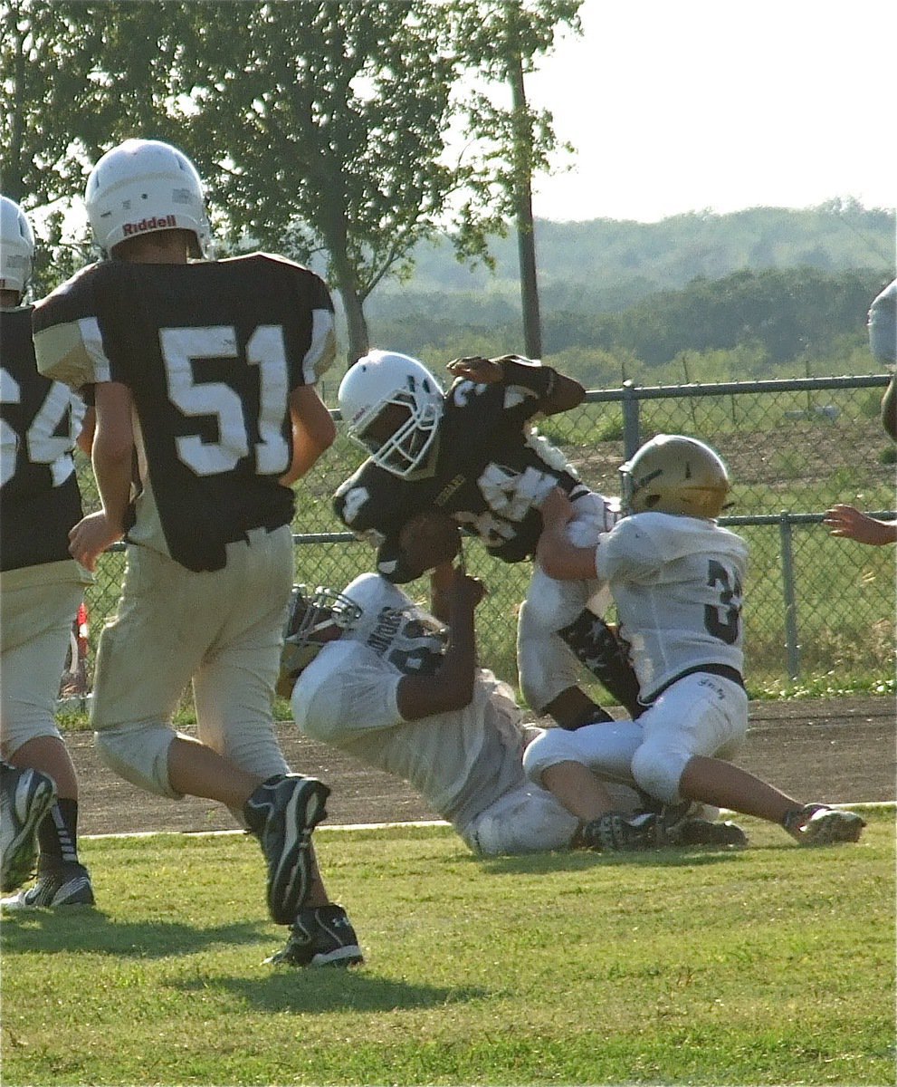 Image: Jarvis Harris(89) and Blake Brewer(30) pull down a Jaguar along Hubbard’s sideline.