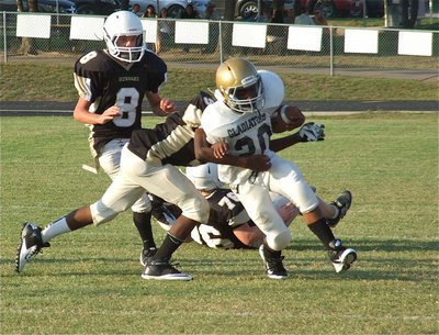 Image: Kendrick Norwood(20) running hard against the Jaguars to help Italy shutout Hubbard 12-0 during the Junior High matchup.