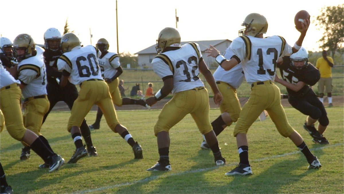 Image: Center Kyle Fortenberry(76), John Hughes(60), Billy Moore(32) and John Byers(75) buy Ryan Connor(13) time to pass in the pocket.