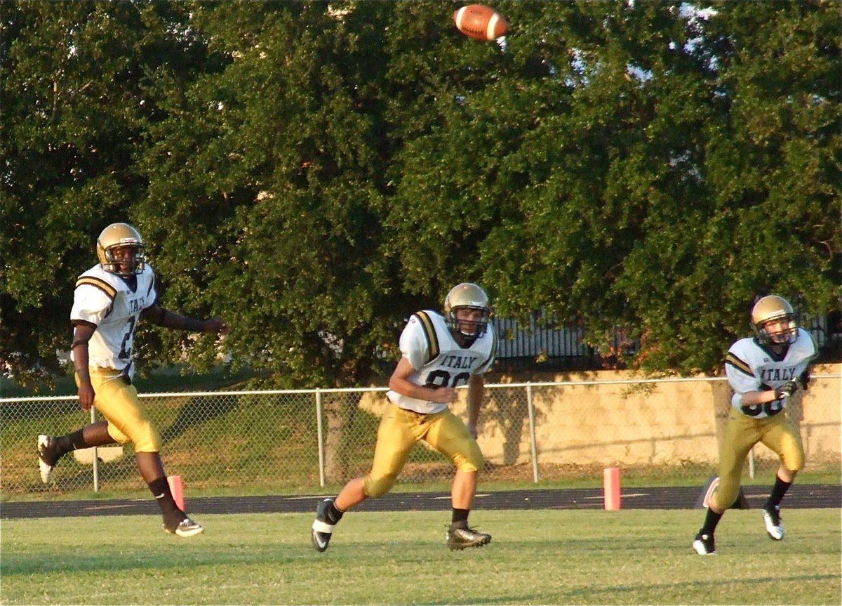 Image: Marvin Cox(2) kicks off as brothers Hunter Merimon(86) and Clayton Miller(88) head upfield to cover.