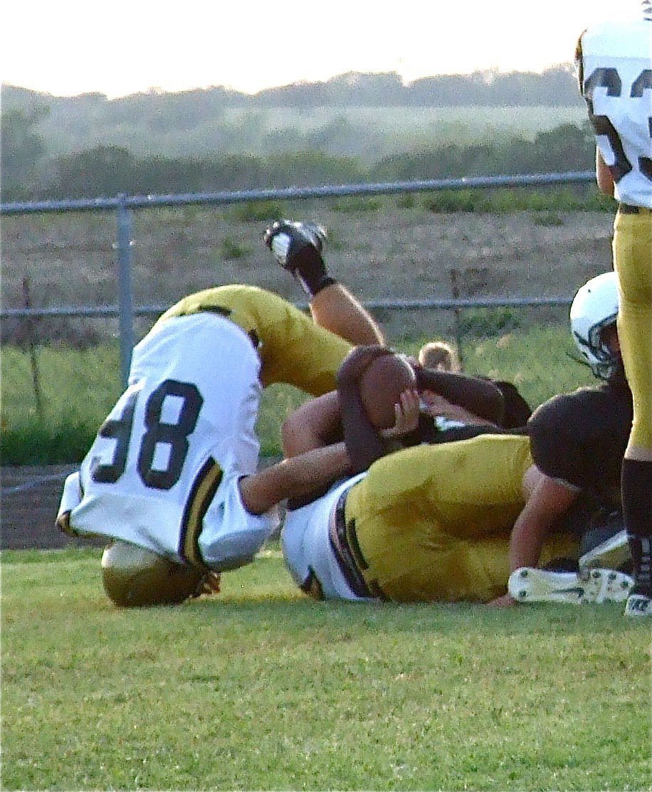 Image: John Byers(75) makes the tackle while teammate Hunter Merimon(86) tries to strip the ball.