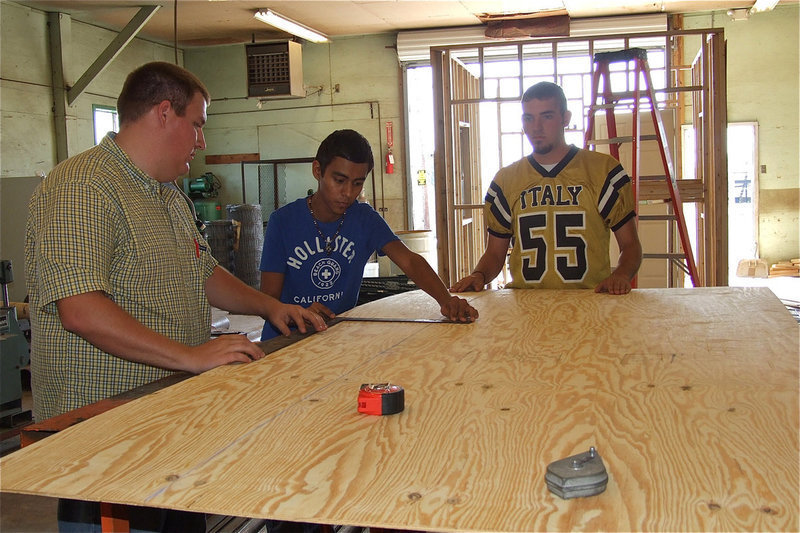 Image: IHS Ag Teacher Blake Godwin oversees the construction of a visitor side concession stand for the football field.