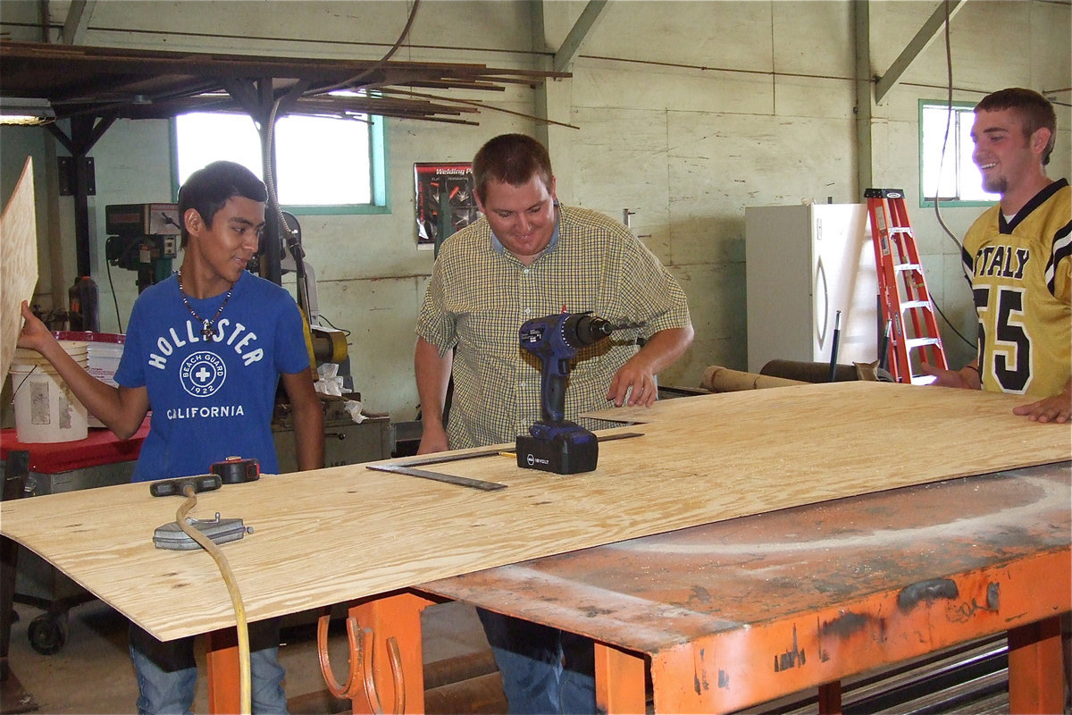 Image: Senior Edgar Salazar, Mr. Godwin, and senior Zackery Boykin have a chuckle at the Ag Teacher’s expense.