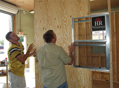 Image: Zack and Mr. Godwin fit a side wall into place.