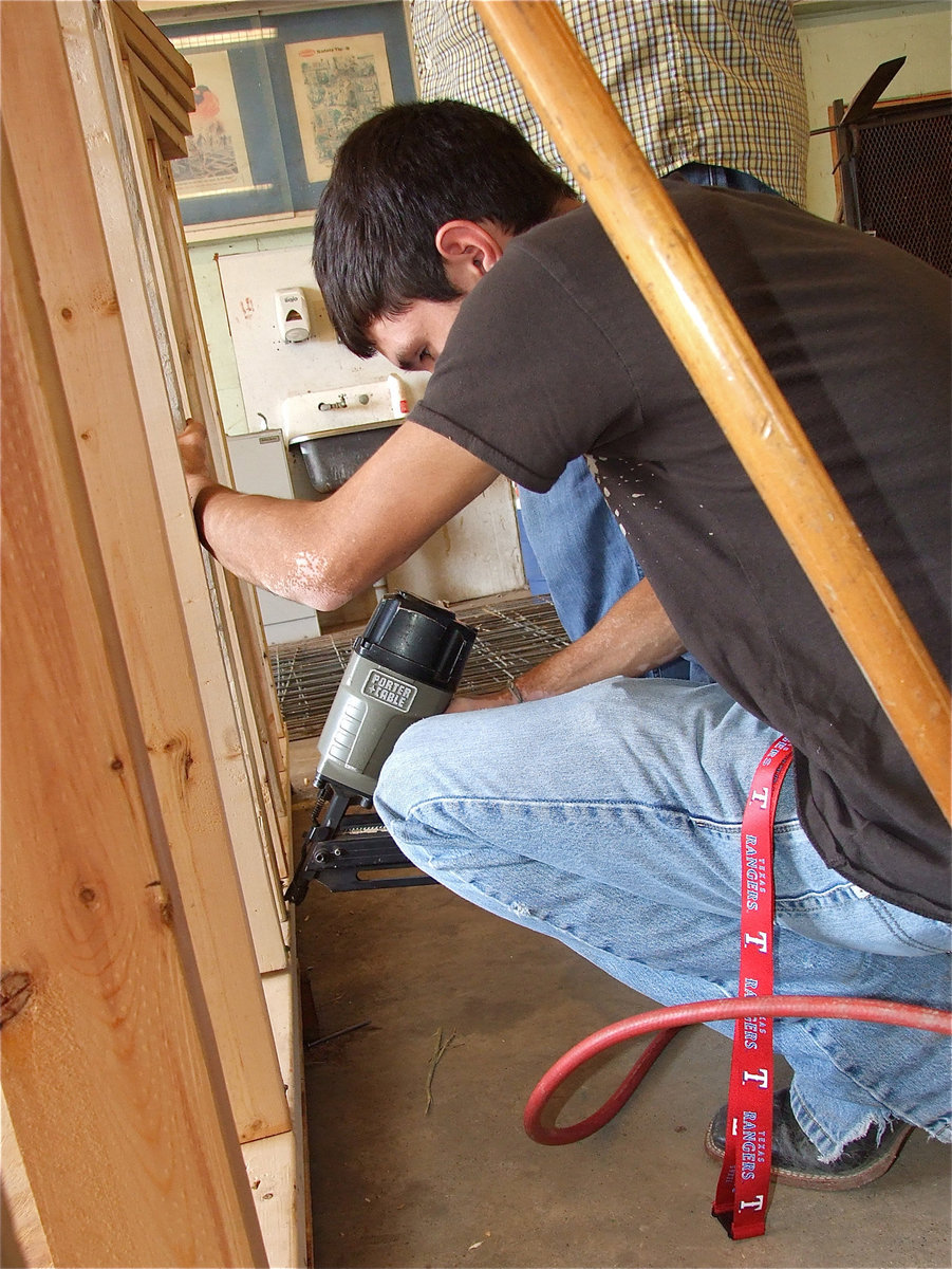 Image: Brandon Jacinto nails an extra support stud into the wall’s frame.