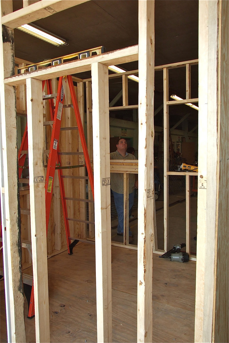 Image: Mr Godwin admires the almost done stage of the concession stand.