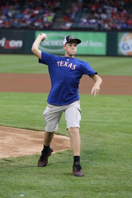 Image: Clay Riddle throwing the ceremonial “first pitch”