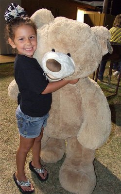 Image: Ella and Chubs: Ella places the biggest bid on the teddy bear during the silent auction held in honor of Andrea Hooker who recently underwent a heart transplant.