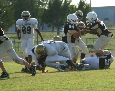 Image: Aaron Pittman(50) brings down a Hubbard Jaguar during the Junior High game in Hubbard this past Thursday.