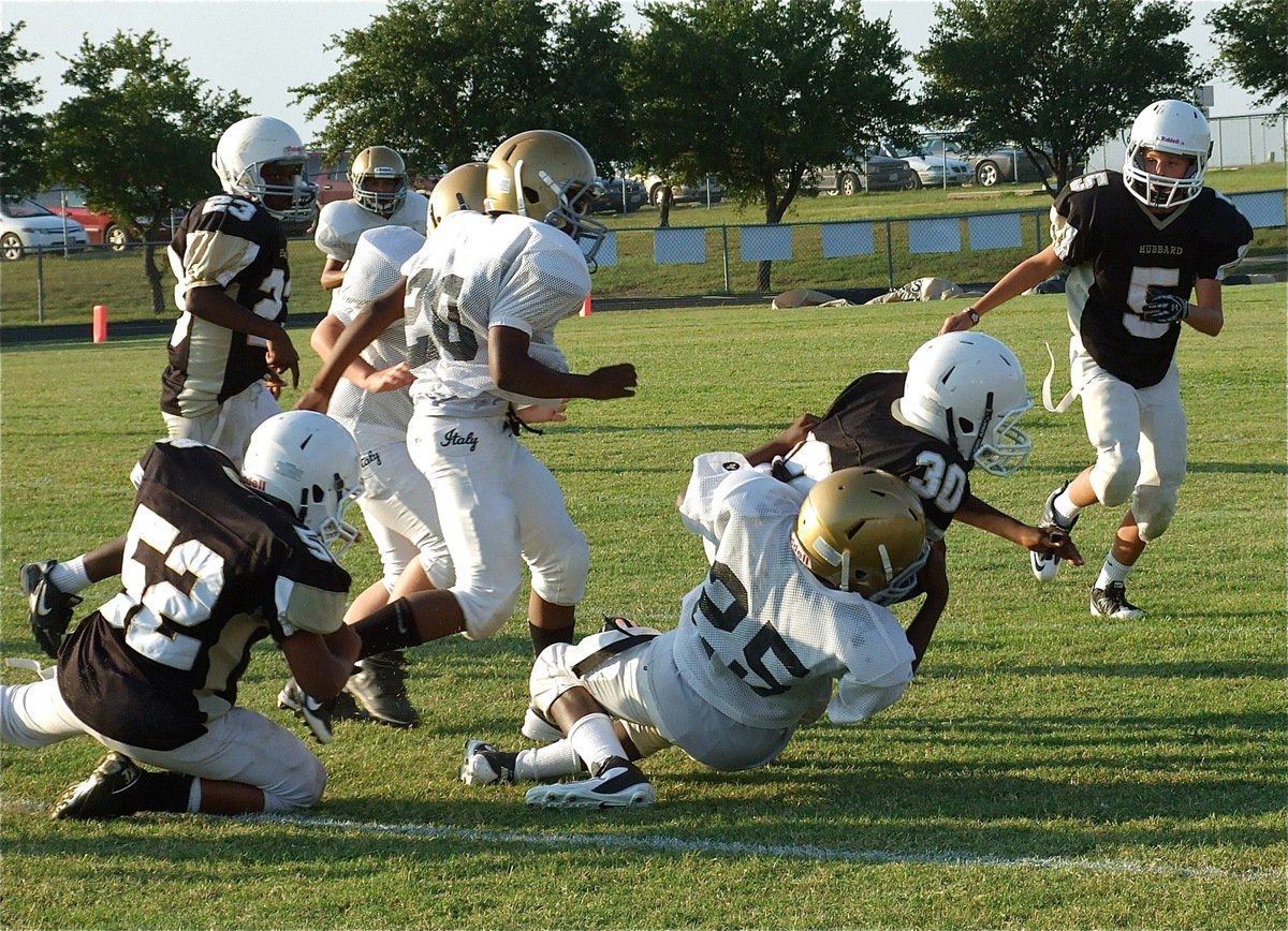 Image: Italy’s Junior High defense makes the tackle in pass coverage.