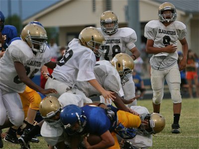 Image: The 8th grade Gladiator defense converges on a Raider runner.