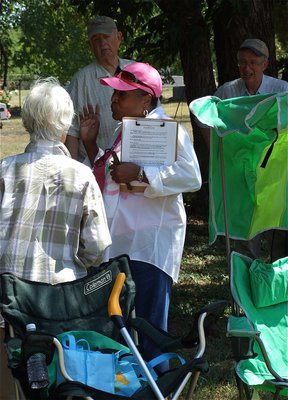 Image: Elmerine Bell discusses the game plan with a fellow activists including Frances James and Rex Carey. Carey, on the far right, has been working with Elmerine Bell since the beginning of the devastation at St. Mary Cemetery.