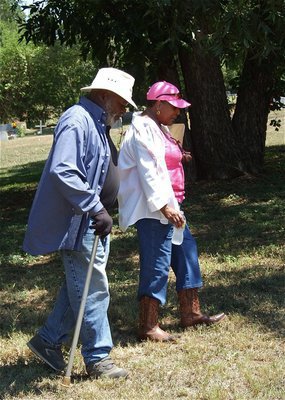 Image: Aaron Pyburn of Desoto and Elmerine Bell walk the St. Mary Cemetery grounds while discussing the next step in the fight to SAVE St. Mary Cemetery.