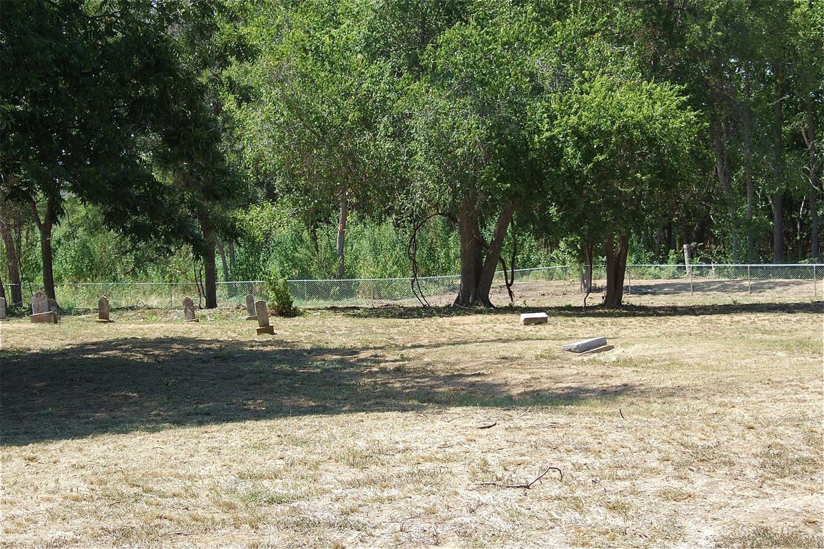 Image: This shows a portion of the newly erected chain-link fence that defines a dirt road carved out by the Creek Land &amp; Cattle Company who destroyed burial plots during the process.