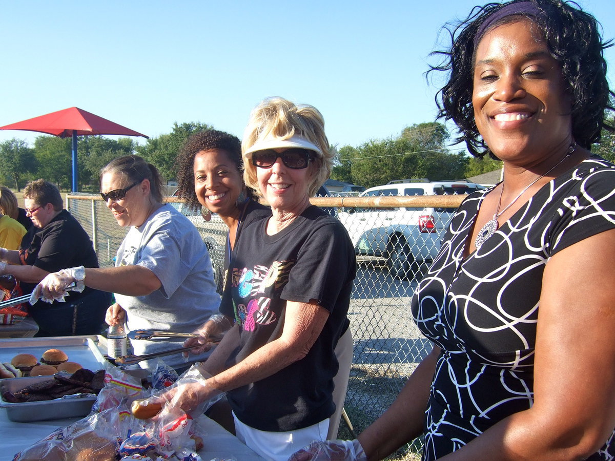 Image: Dedicated teachers, principal and staff working hard at making the family picnic a success.