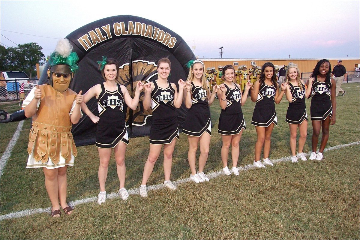 Image: The Gladiator cheerleaders during the school song before the game between Italy and Hubbard.