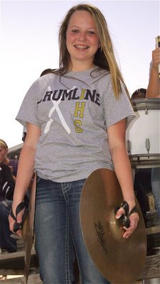 Image: Band member Maddie Pittman displays the drumline’s new shirts.