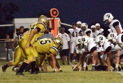 Image: Justin Wood(44), Cody Medrano(75) and their defensive teammates try to contain the Hubbard offense on Italy Friday night.