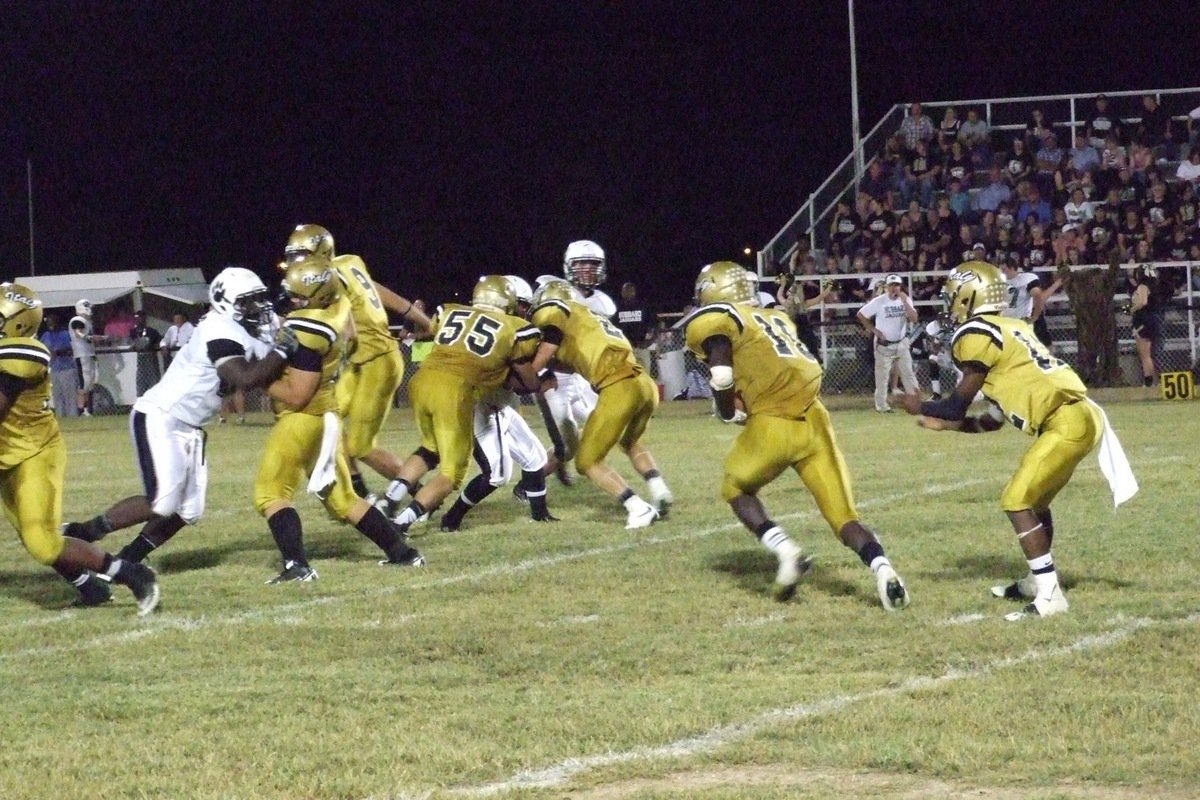 Image: Quarterback Eric Carson(12) hands off to Ryheem Walker(10) who runs behind blockers Darol Mayberry(58), Kevin Roldan(60), Cole Hopkins(9), Zackery Boykin(55) and Chase Hamilton(2).