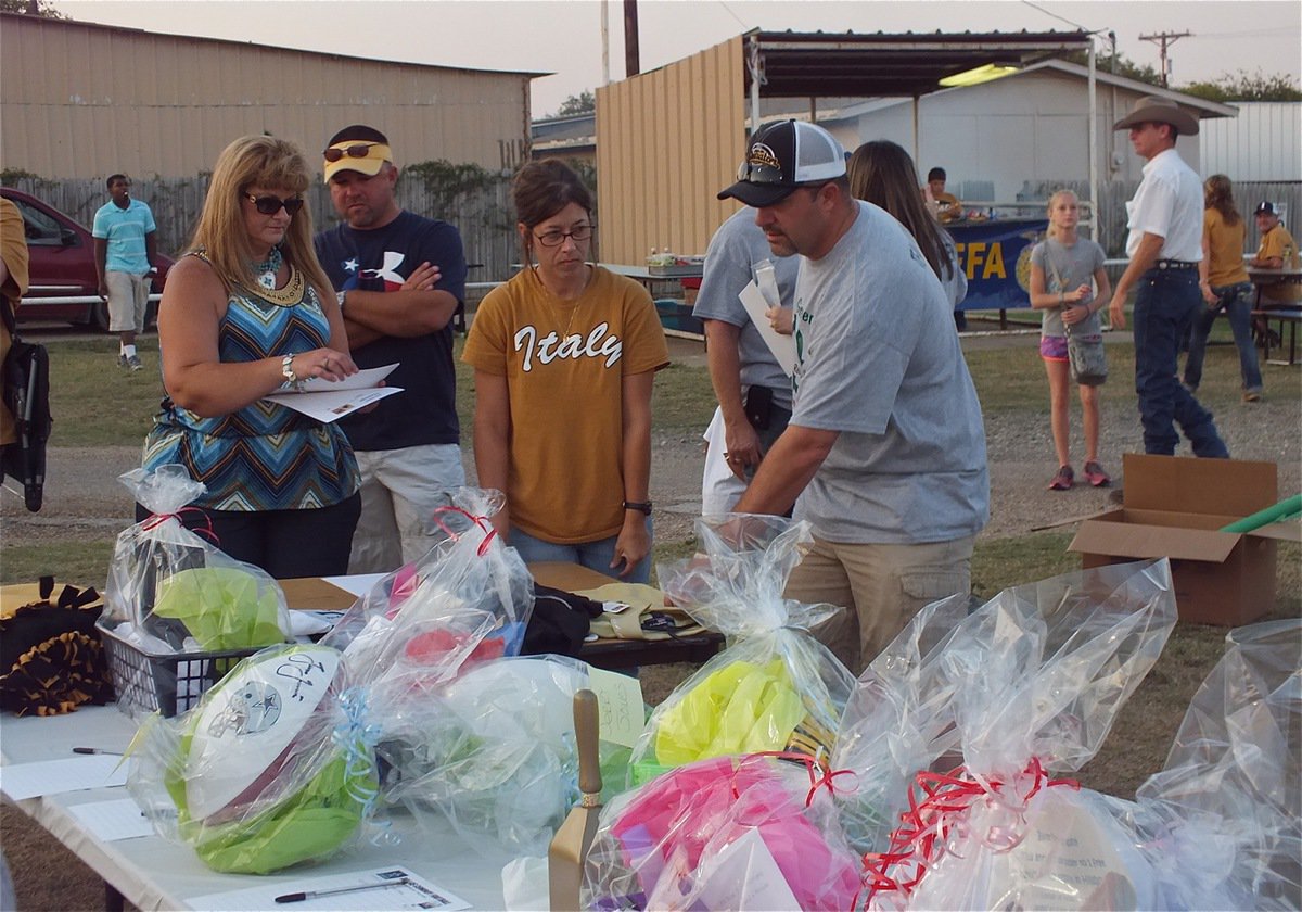 Image: Team Hooker member, Mark Souder, helps fans bid during the silent auction to benefit the Hooker Family.