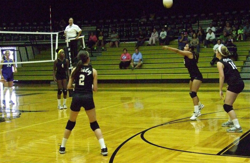 Image: Ashlyn Jacinto(10) bumps the ball into the air while K’Breona Davis(4), Cassidy Childers(2) and Taylor Turner(14) await the result.