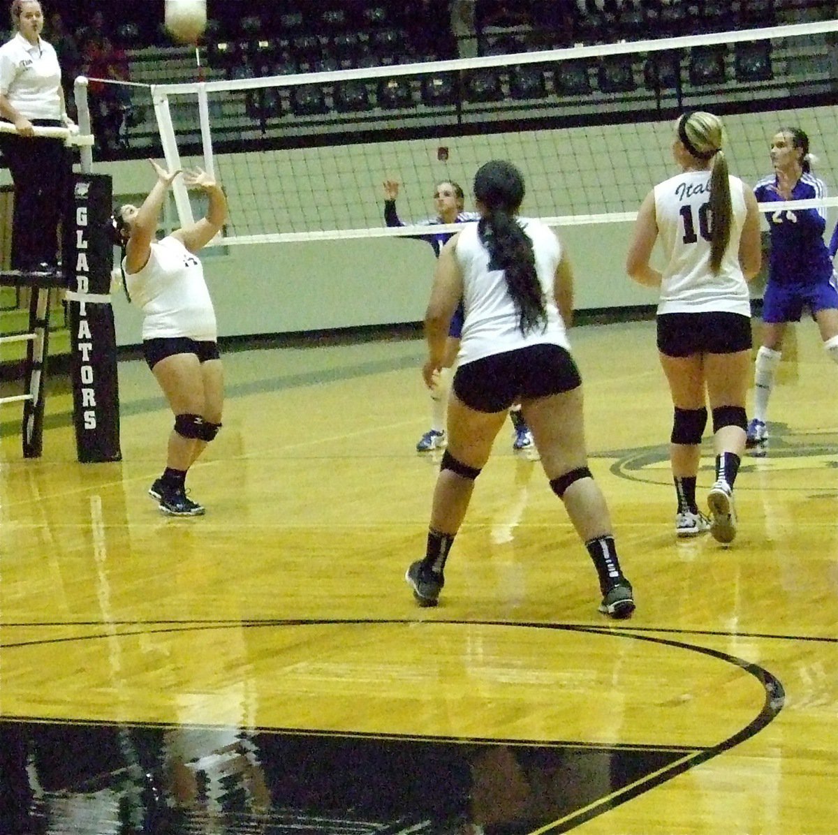 Image: In the varsity matchup between Italy and Frost, Monserrat Figueroa(14) sets the ball for her teammates Alyssa Richards(13) and Madison Washington(10).