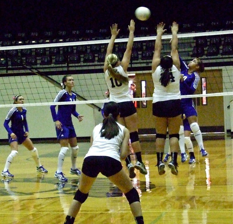 Image: Madison Washington(10), Monserrat Figueroa(14) go for the block at the net with teammate Paola Mata(2) backing them up.