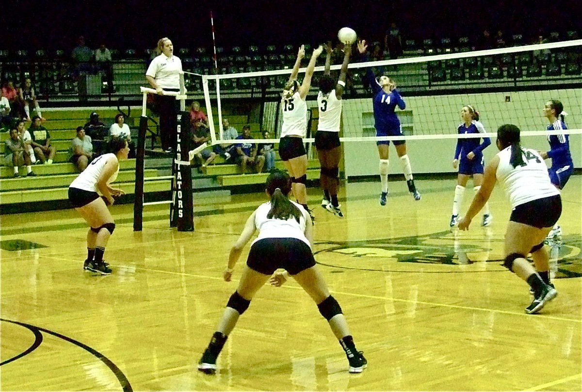 Image: Jaclynn Lewis(15) and Kortnei Johnson(3) blanket the return from Frost while Alyssa Richards(13), Paola Mata(2) and Monserrat Figueroa(14) are ready converge to the ball.