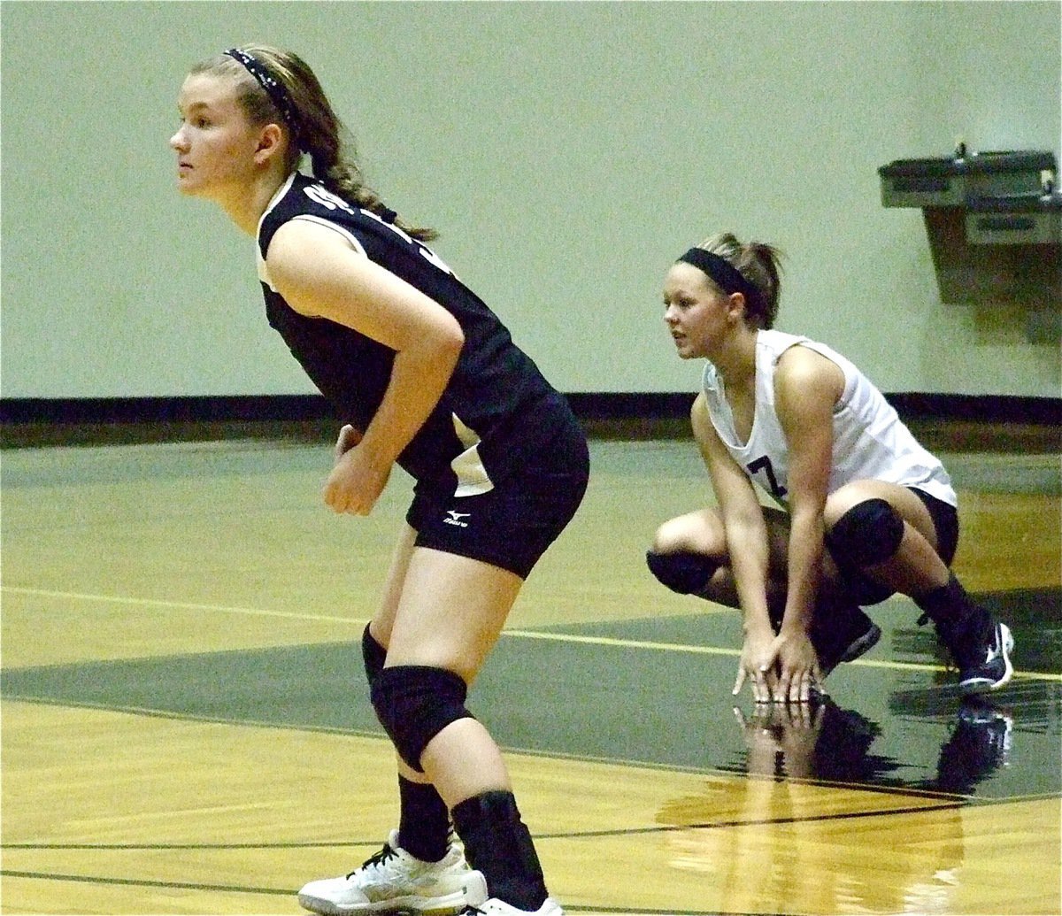 Image: On defense, Tara Wallis(5) and Bailey Eubank(11) prepare for a Frost serve.