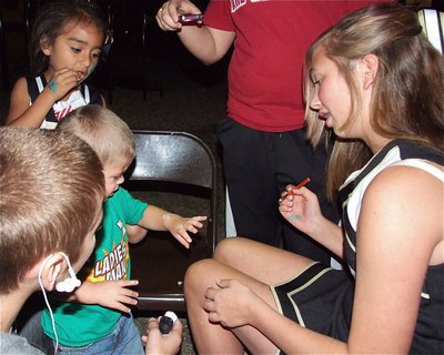 Image: IJH Cheerleader Meagan Connor works the face painting booth but hands and arms were painted also.