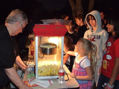 Image: Sue Lauhoff off the Italy Police Department prepares popcorn for anxiously awaiting guests during National Night Out hosted by the I.P.D. at the George E. Scott Memorial Park on Tuesday night.