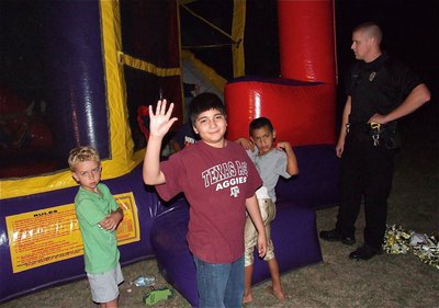 Image: Creighton Hyles, Andrew Celis and Jaylon Wallace are ready to try the bounce house with Officer Thompson monitoring the situation and decides not to call for backup.